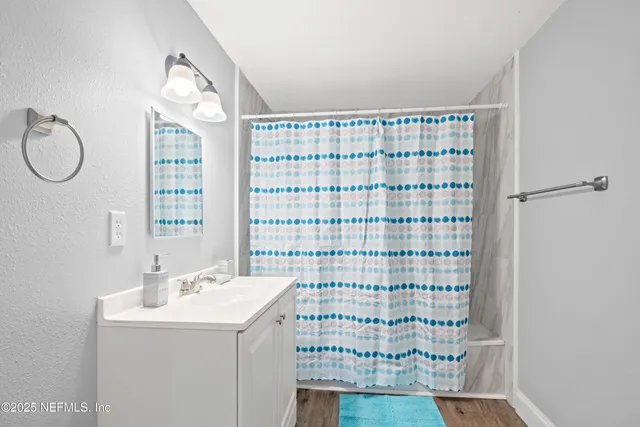 a bathroom with a sink a vanity and a shower