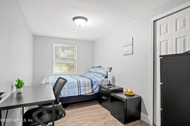 a bedroom with a bed and a potted plant