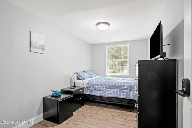 a bedroom with a bed and a flat screen tv