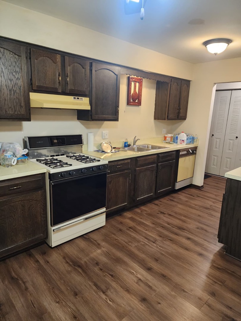 235 North Mill Road, Unit 106B Addison, IL 60101 - Photo 11 of 22 a kitchen with stainless steel appliances granite countertop a stove a sink and a refrigerator