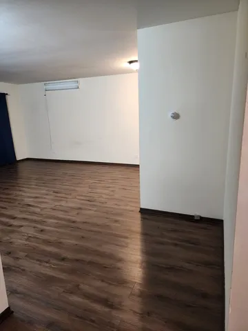 a room with wooden floor and shoes