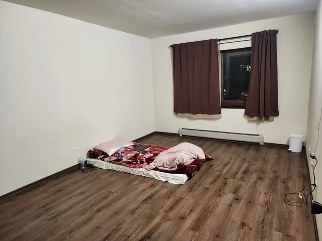 a view of a closet with wooden floor