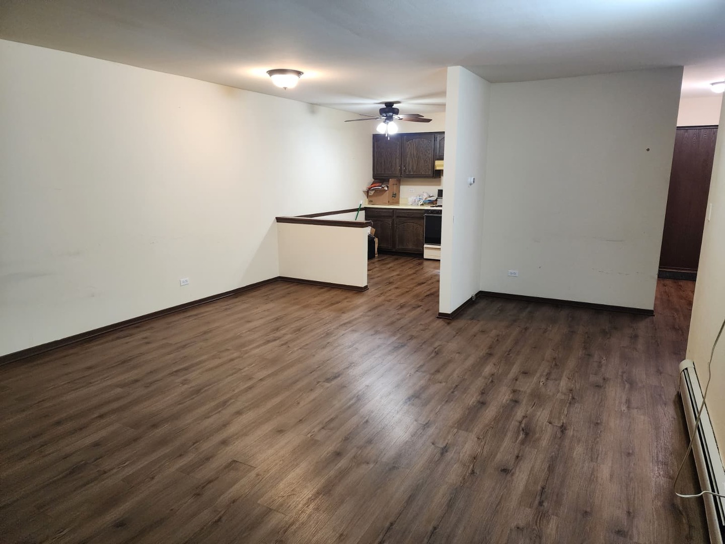 235 North Mill Road, Unit 106B Addison, IL 60101 - Photo 16 of 22 a room with wooden floor and furniture