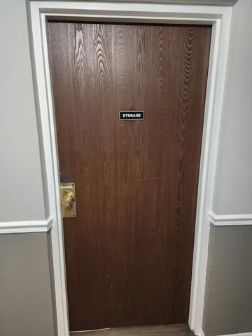 a view of storage and utility room with a window