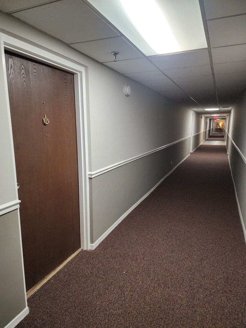 235 North Mill Road, Unit 106B Addison, IL 60101 - Photo 7 of 22 a view of a hallway with seating area