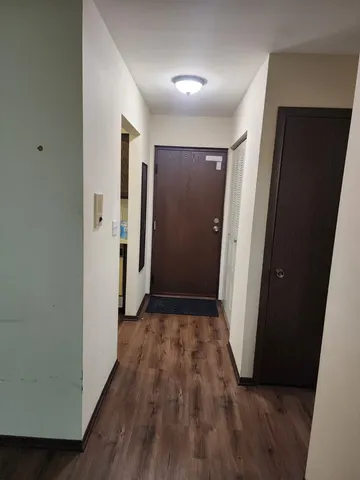 a kitchen with sink cabinets and wooden floor