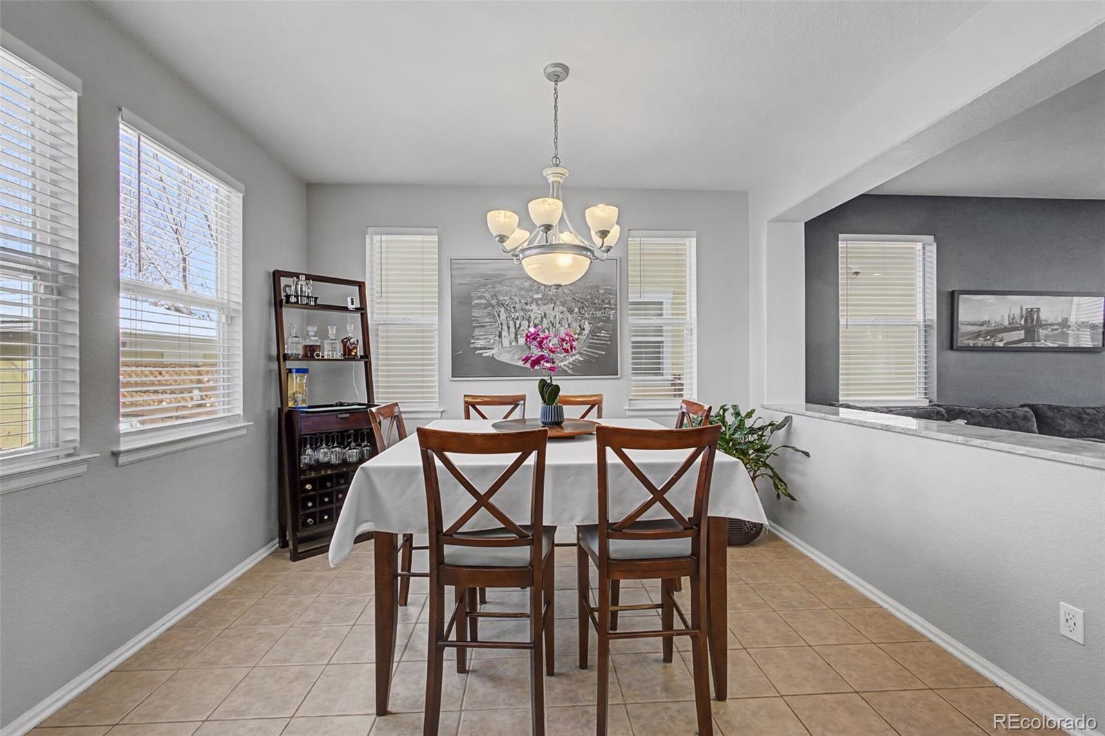 2921 Fulton Street Denver, CO 80238 - Photo 11 of 42 a dining room filled chandelier and wooden floor