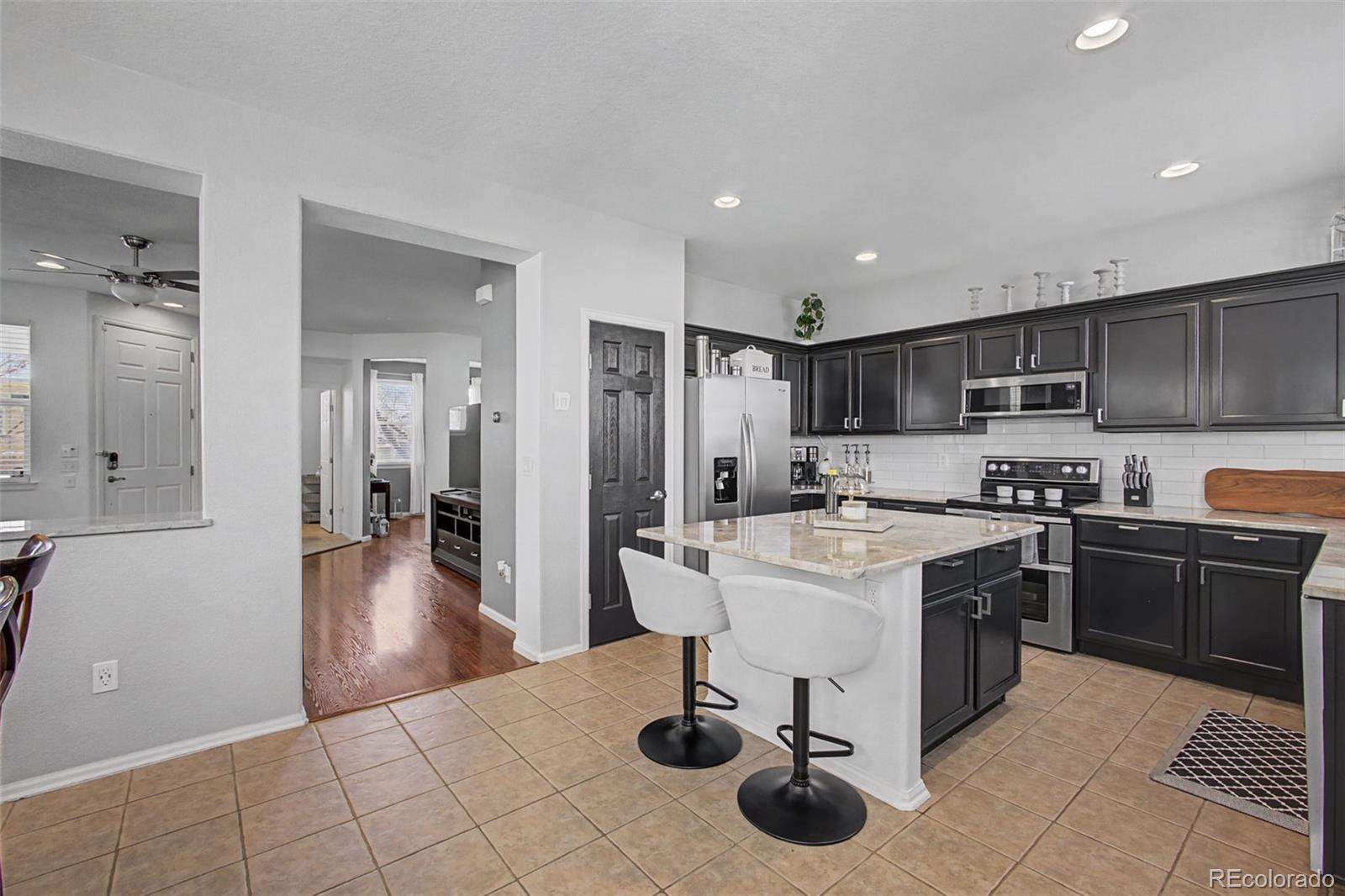 2921 Fulton Street Denver, CO 80238 - Photo 13 of 42 a kitchen with a sink a stove and cabinets