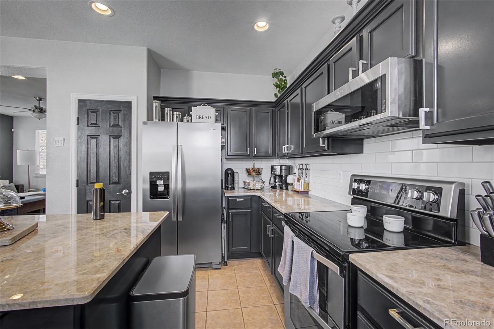 2921 Fulton Street Denver, CO 80238 - Photo 14 of 42 a kitchen with stainless steel appliances granite countertop a sink a stove and a refrigerator