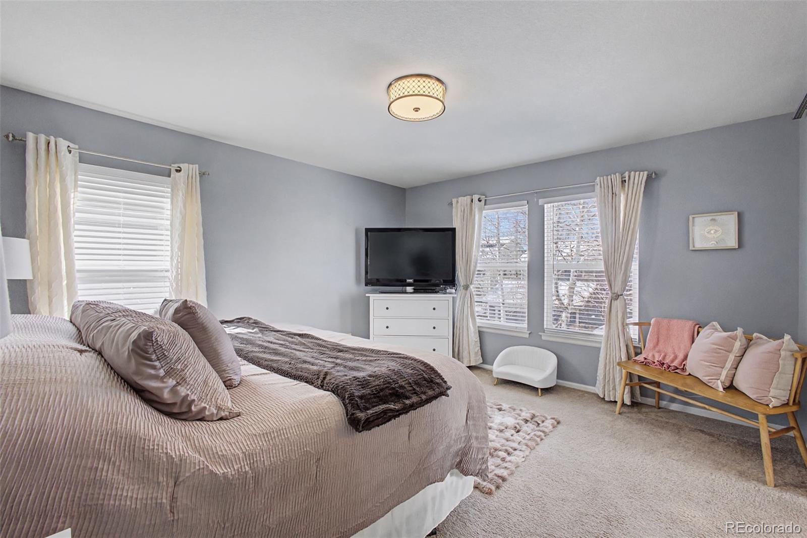 2921 Fulton Street Denver, CO 80238 - Photo 17 of 42 a bedroom with a bed and a flat screen tv