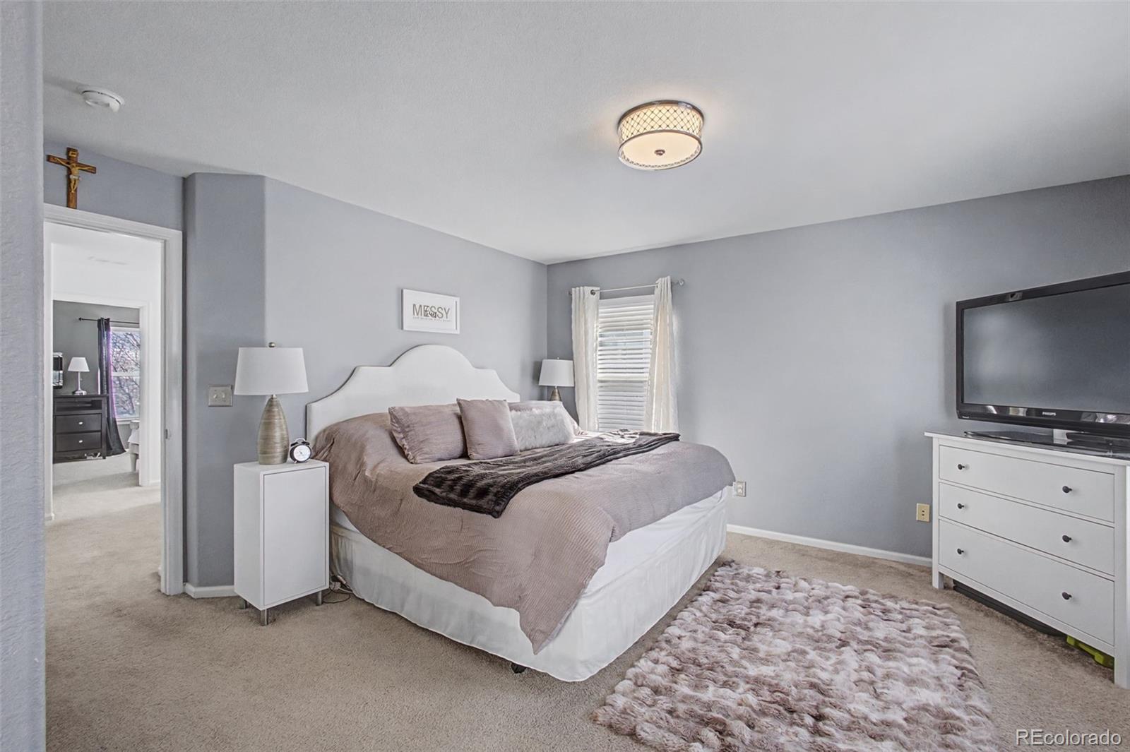2921 Fulton Street Denver, CO 80238 - Photo 18 of 42 a bed room with a bed and a television