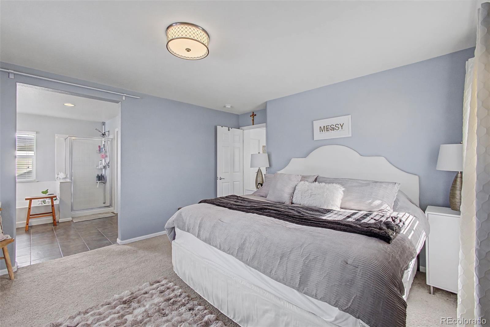 2921 Fulton Street Denver, CO 80238 - Photo 20 of 42 a bedroom with a large bed and a chandelier