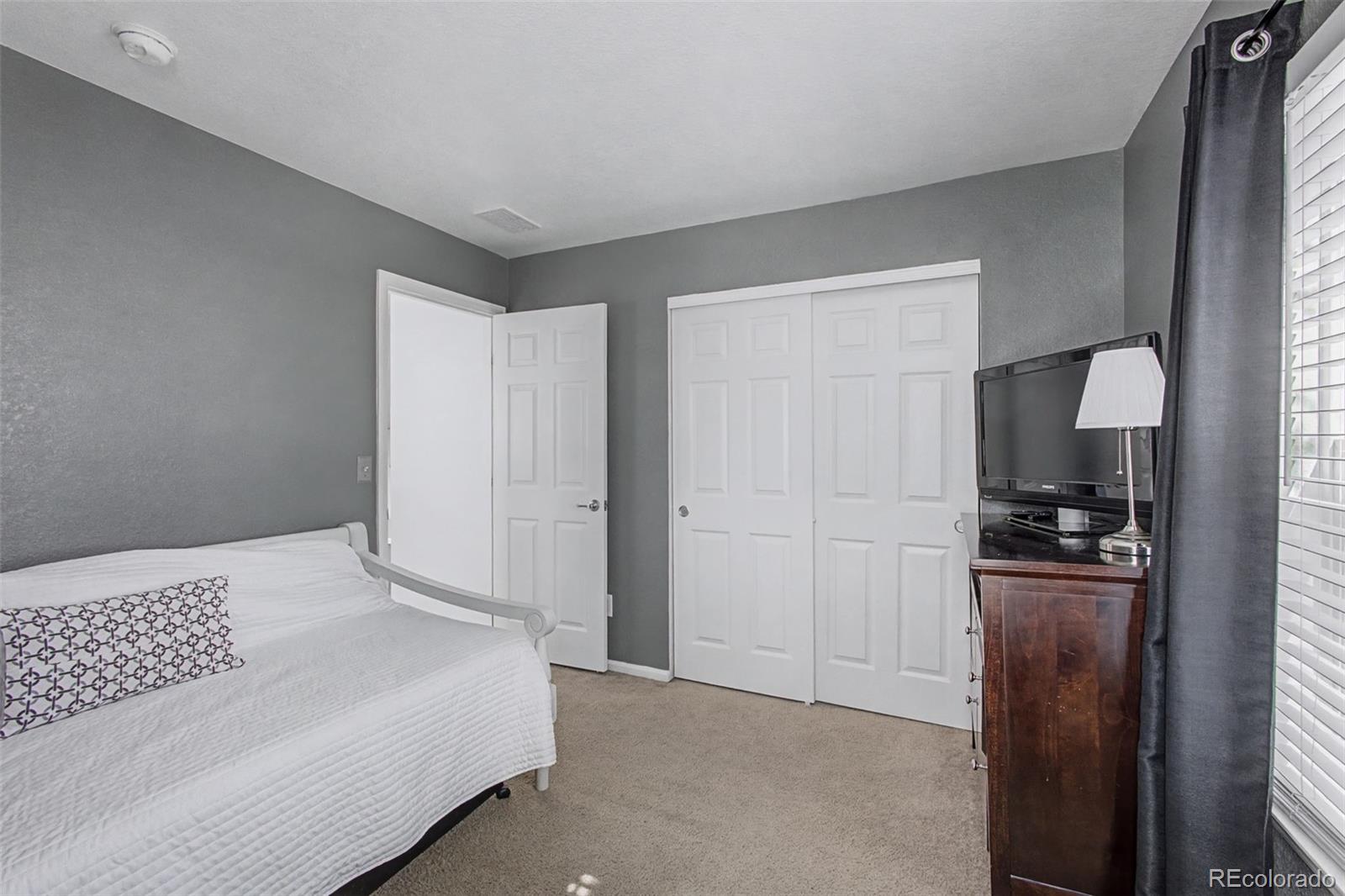 2921 Fulton Street Denver, CO 80238 - Photo 26 of 42 a bedroom with a bed and a stove