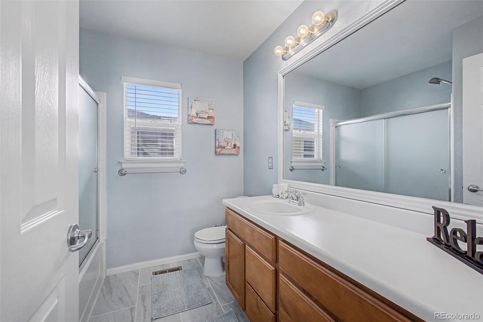 2921 Fulton Street Denver, CO 80238 - Photo 27 of 42 a bathroom with a sink a toilet a shower and a mirror