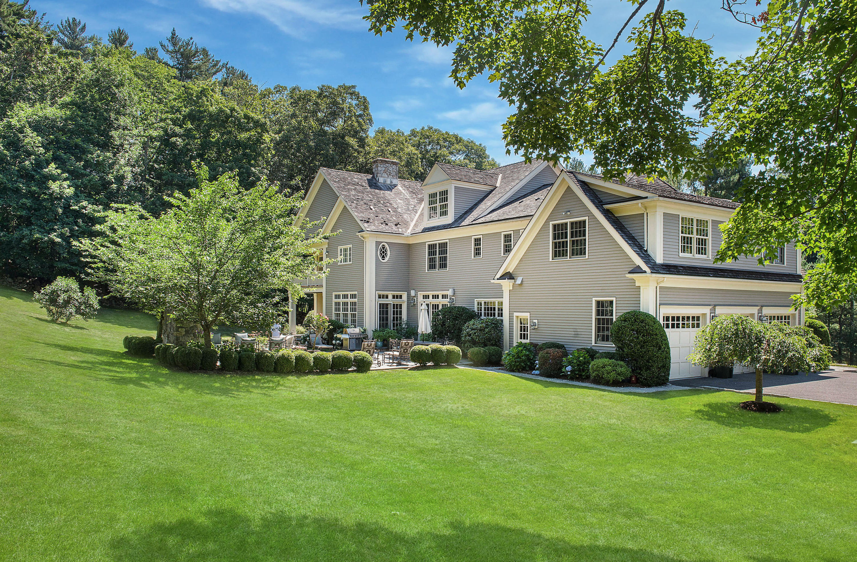 20 Silvermine Road New Canaan, CT 06840 - Photo 43 of 45 a front view of a house with a yard and trees
