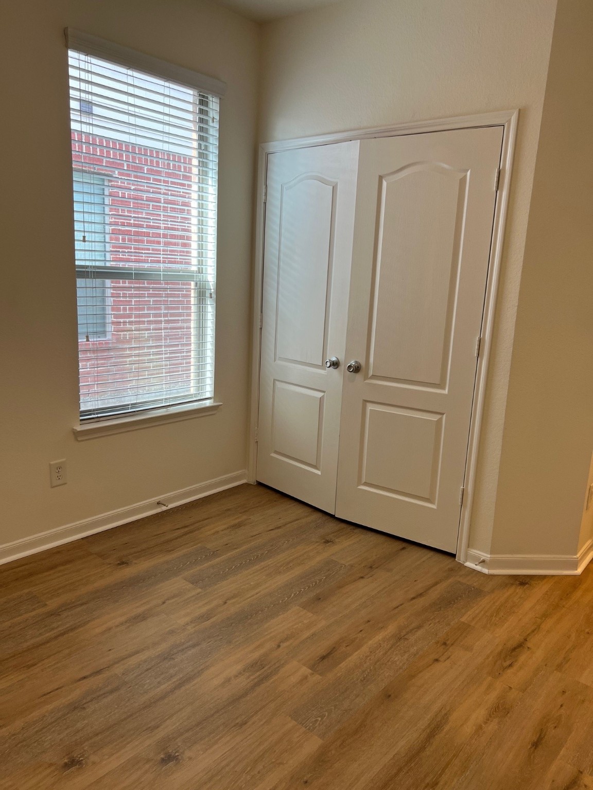 22511 Bellwick Ridge Lane Katy, TX 77449 - Photo 11 of 14 a view of an empty room with wooden floor and a window