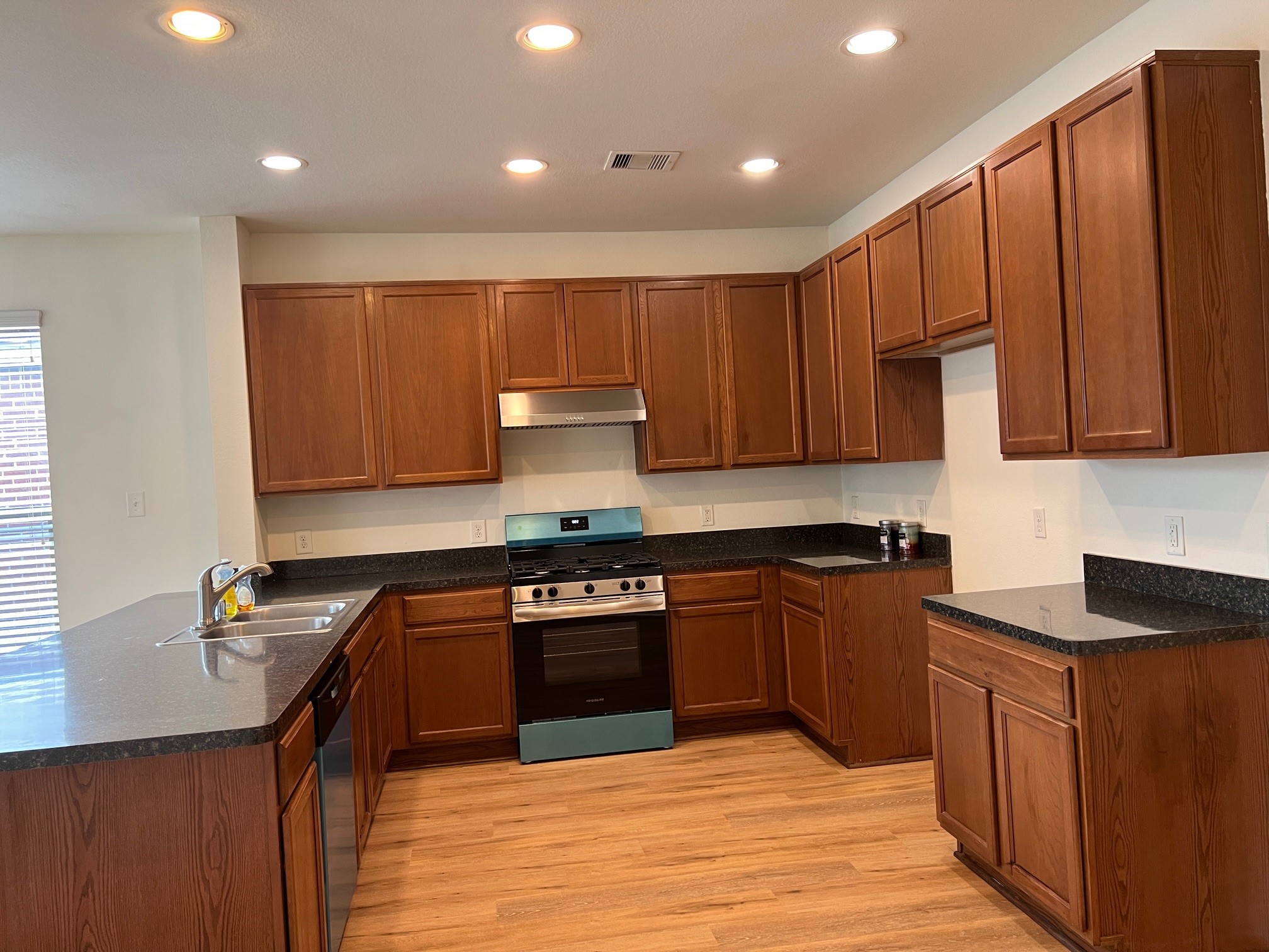 22511 Bellwick Ridge Lane Katy, TX 77449 - Photo 4 of 14 a kitchen with wooden cabinets and a sink