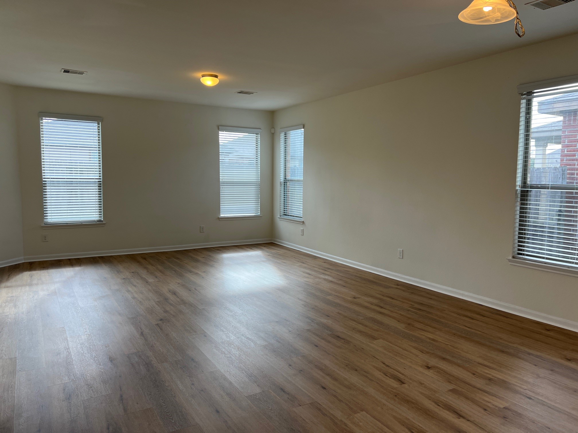 22511 Bellwick Ridge Lane Katy, TX 77449 - Photo 6 of 14 an empty room with wooden floor and windows
