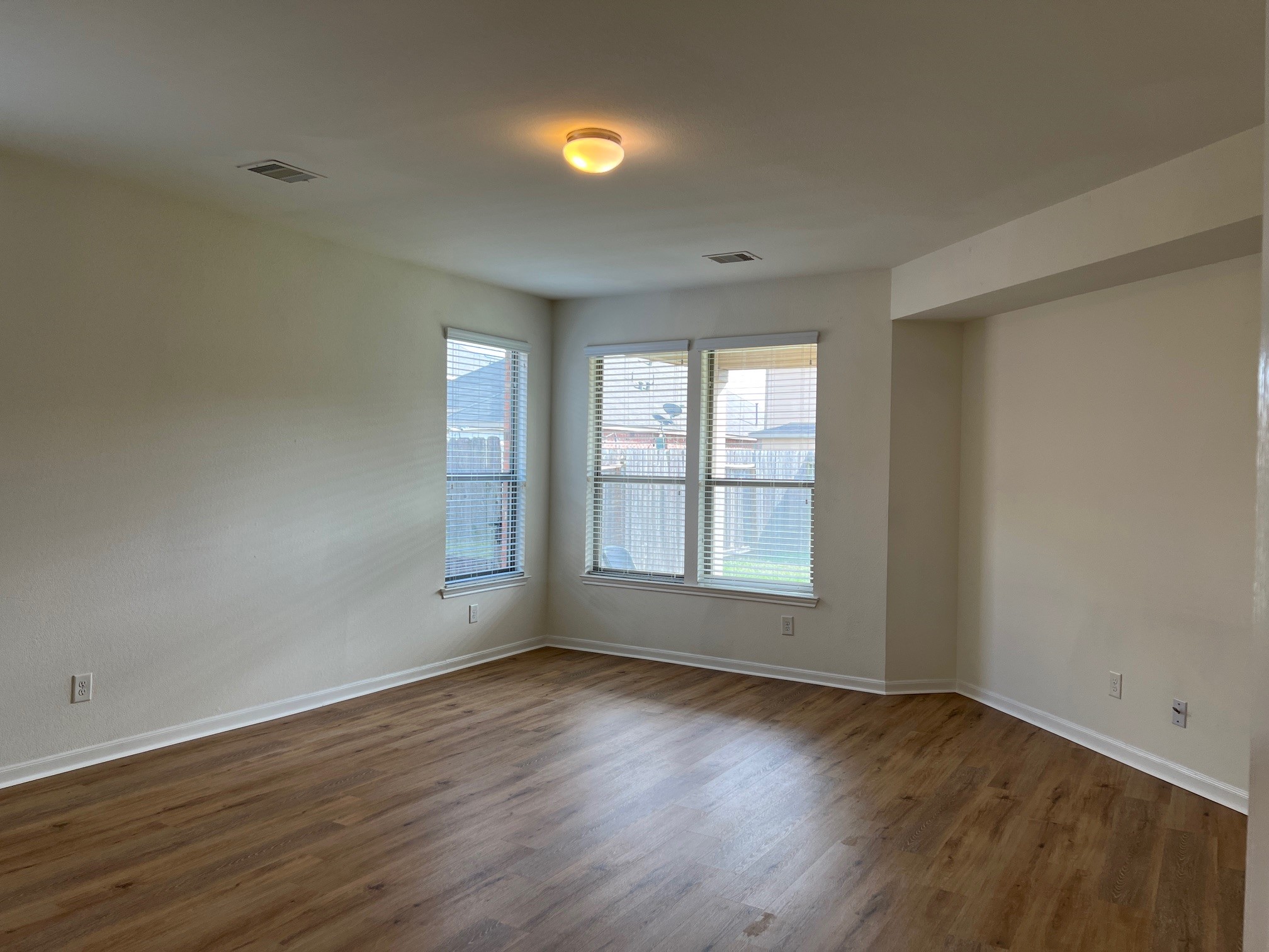 22511 Bellwick Ridge Lane Katy, TX 77449 - Photo 7 of 14 an empty room with wooden floor and windows