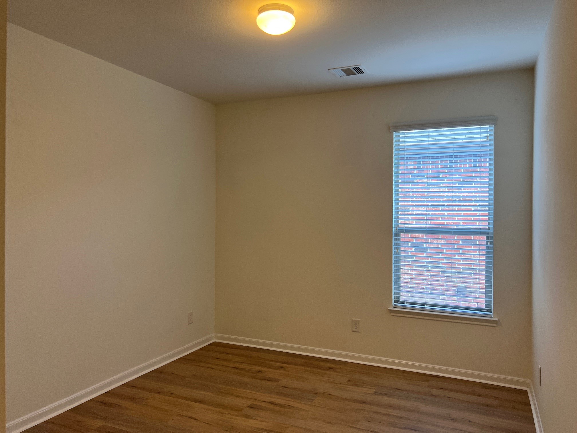 22511 Bellwick Ridge Lane Katy, TX 77449 - Photo 10 of 14 an empty room with wooden floor and windows