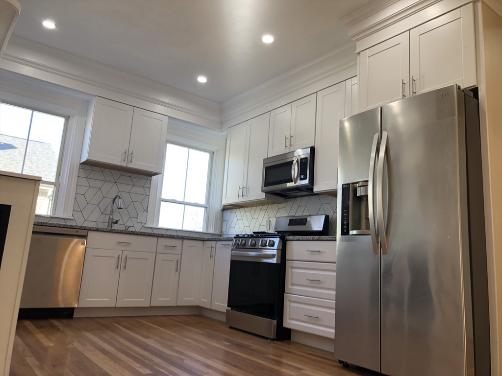 62 Thomas Street, Unit 2 New Bedford, MA 02740 - Photo 1 of 10 a kitchen with stainless steel appliances a refrigerator sink and microwave