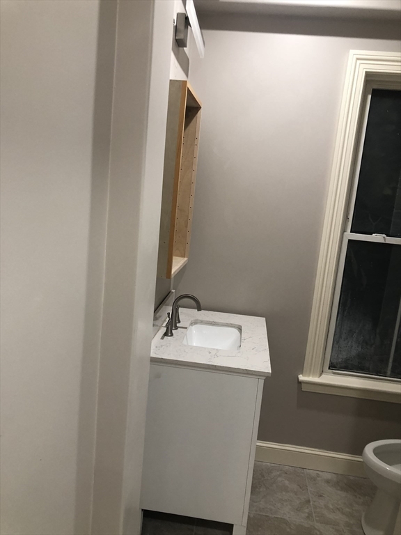 62 Thomas Street, Unit 2 New Bedford, MA 02740 - Photo 8 of 10 a bathroom with a sink and mirror