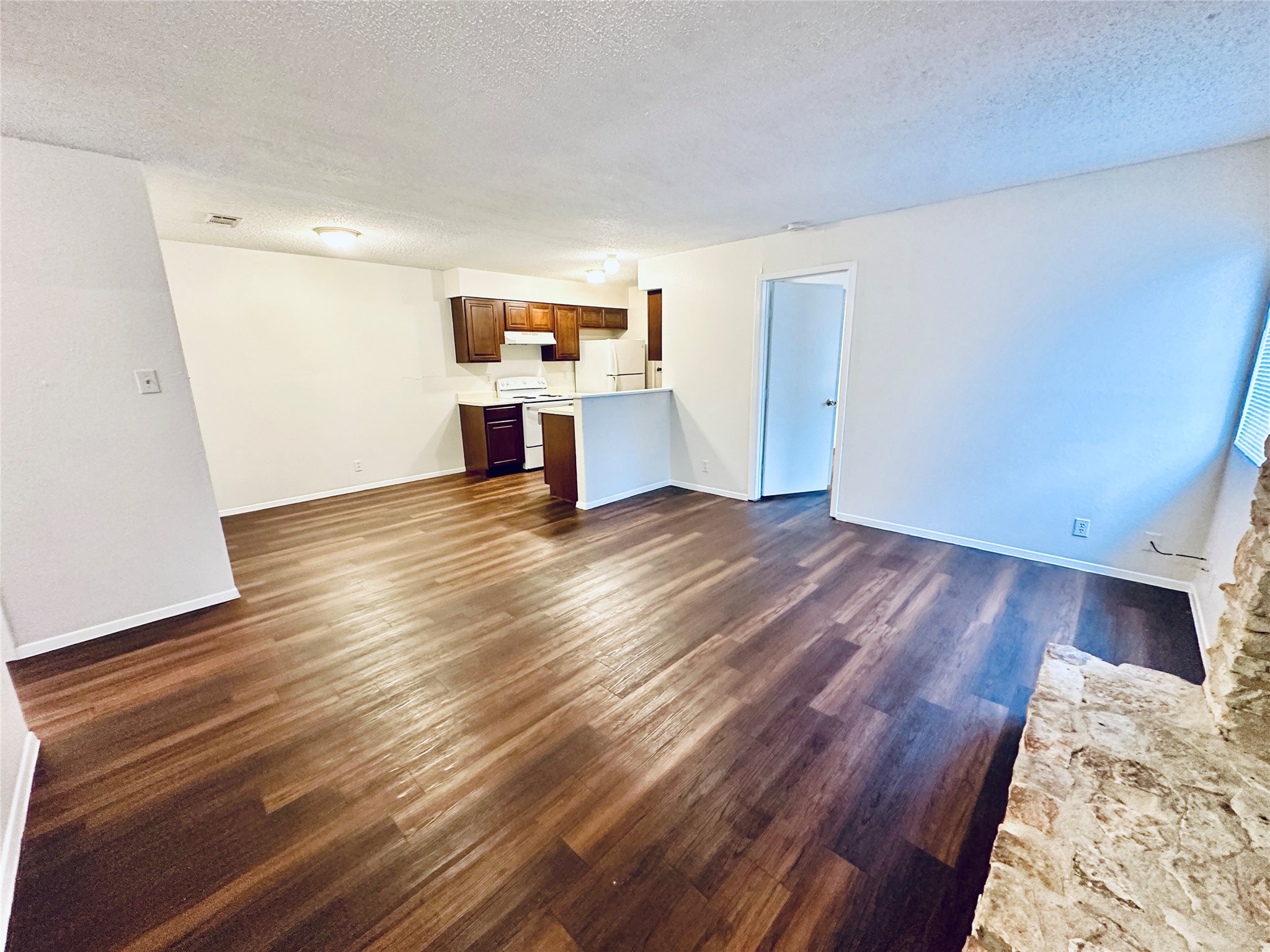 12505 Turtle Rock Road, Unit A Austin, TX 78729 - Photo 10 of 38 Wood flooring and ample natural light define this welcoming open-concept living space.