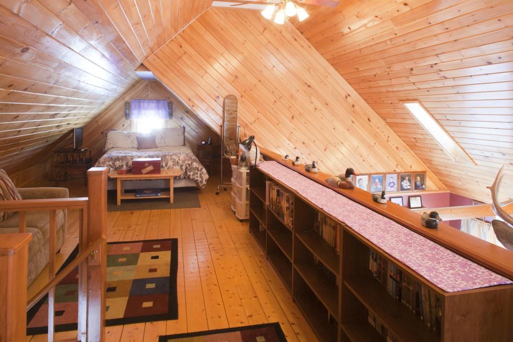 494 Springy Pond Road Ellsworth, ME 04605 - Photo 18 of 34 Bookcases line loft wall