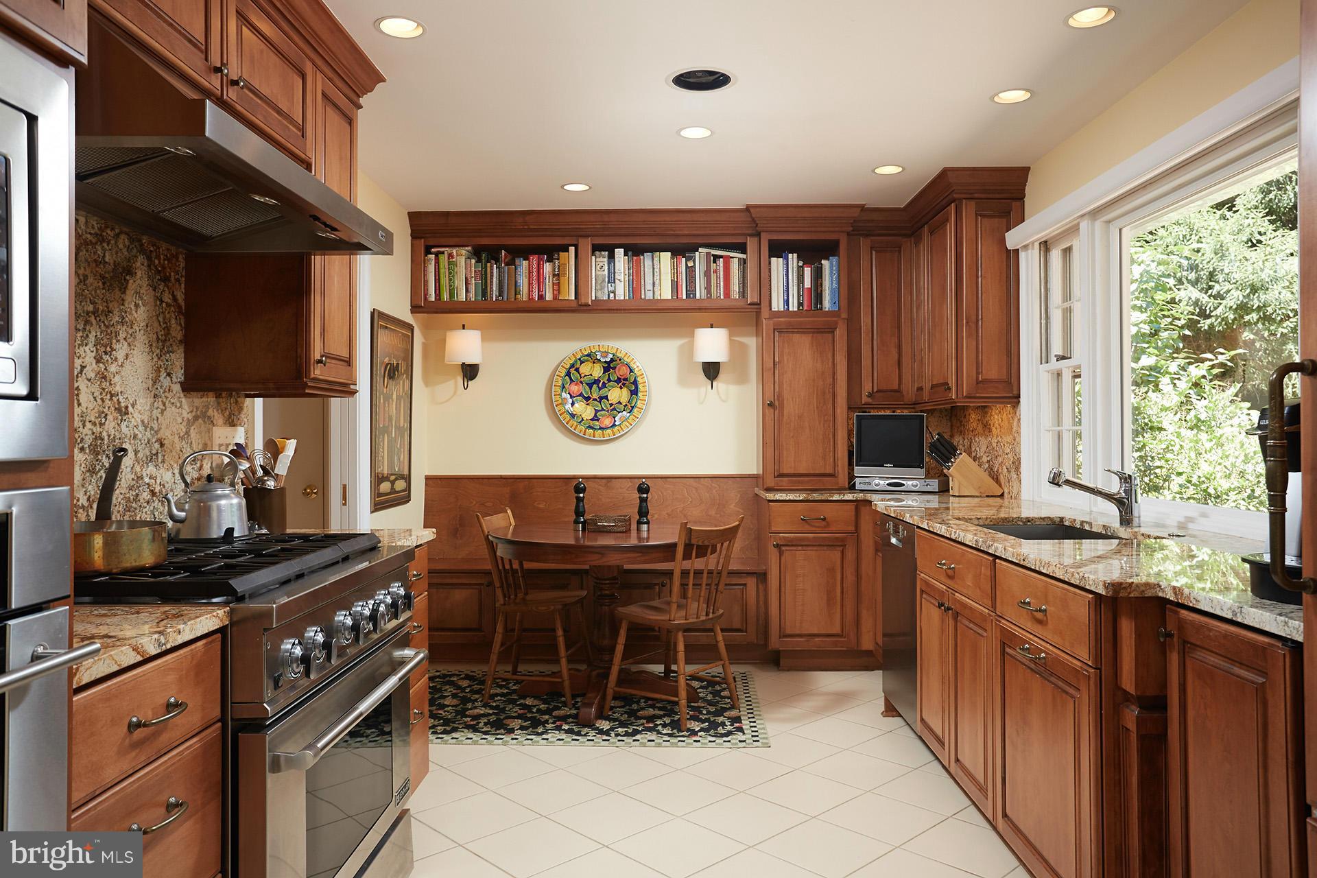 7805 Carteret Road Bethesda, MD 20817 - Photo 8 of 30 a kitchen with stainless steel appliances granite countertop a stove top oven a sink dishwasher and cabinets
