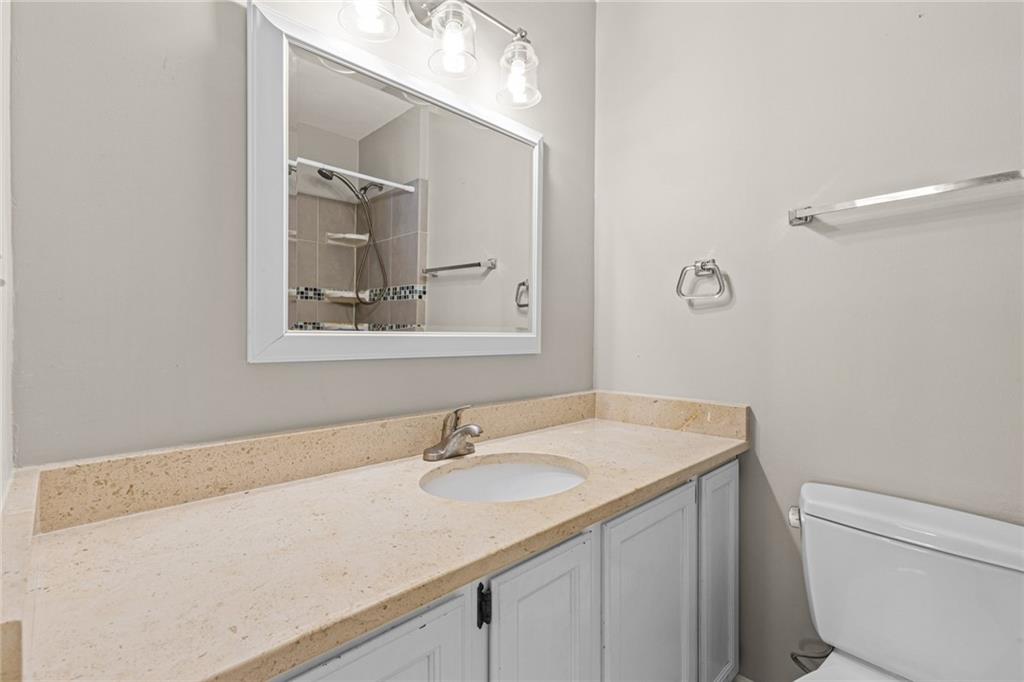 2217 Spring Walk Court Atlanta, GA 30341 - Photo 11 of 23 a bathroom with a sink toilet and mirror