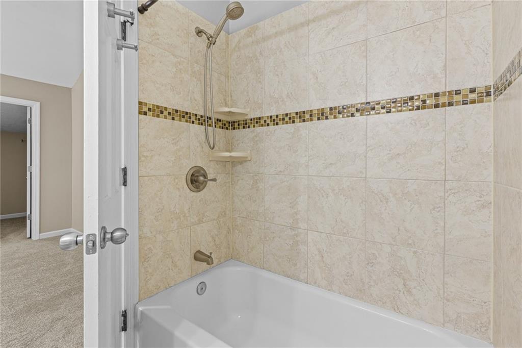 2217 Spring Walk Court Atlanta, GA 30341 - Photo 14 of 23 a bathroom with a bathtub and a shower