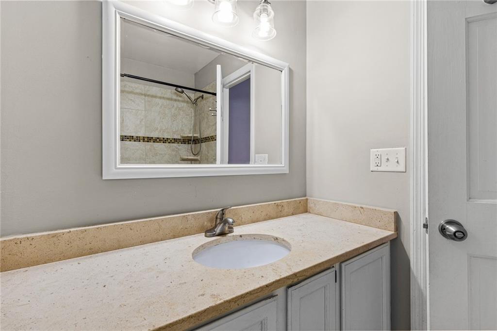 2217 Spring Walk Court Atlanta, GA 30341 - Photo 15 of 23 a bathroom with a granite countertop sink and a mirror