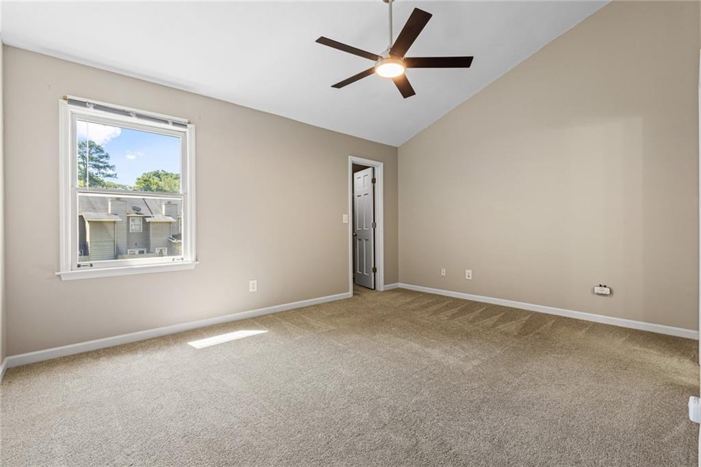 2217 Spring Walk Court Atlanta, GA 30341 - Photo 17 of 23 an empty room with a window and a ceiling fan