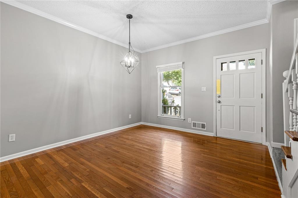 2217 Spring Walk Court Atlanta, GA 30341 - Photo 2 of 23 a view of an empty room with wooden floor and a window