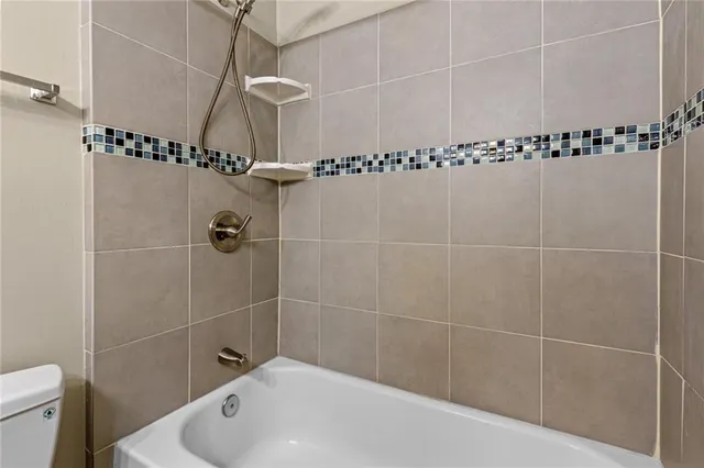 a bathroom with a shower and a toilet