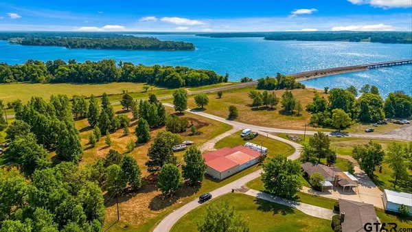 an aerial view of residential houses with outdoor space and swimming pool