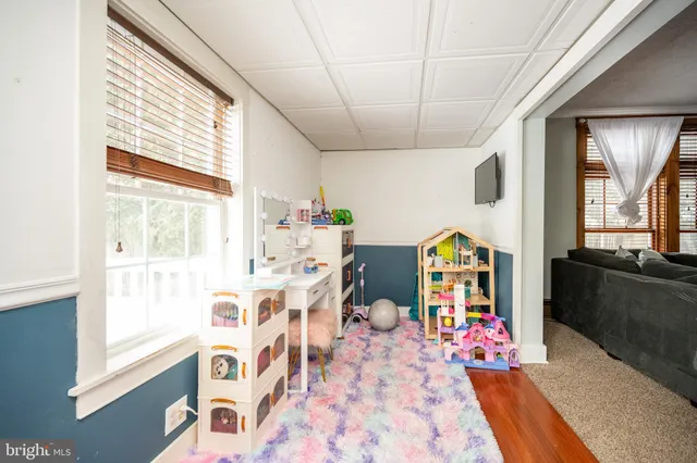 a spacious bedroom with a bed and a chandelier