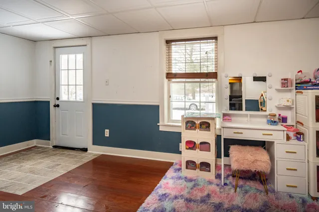 a bedroom with a bed couch and a window
