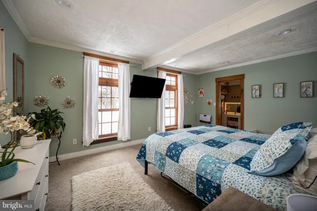 a view of a hallway with a livingroom with furniture