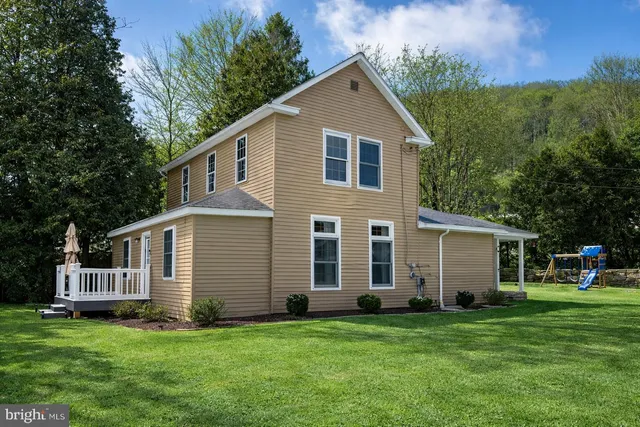 a view of a house with a yard covered in snow