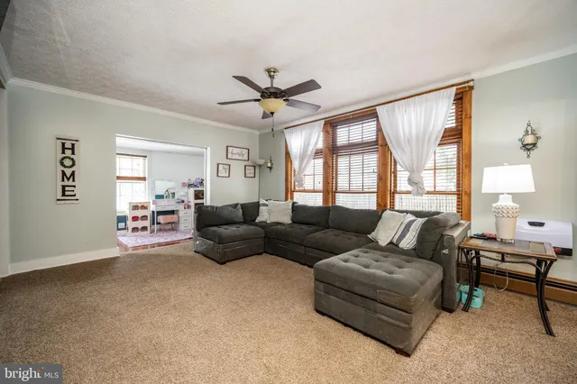a living room with a fireplace and next to a window