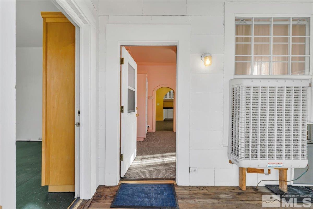 614 Valley Road Reno, NV 89512 - Photo 8 of 40 a view of a hallway with wooden floor and a dining room