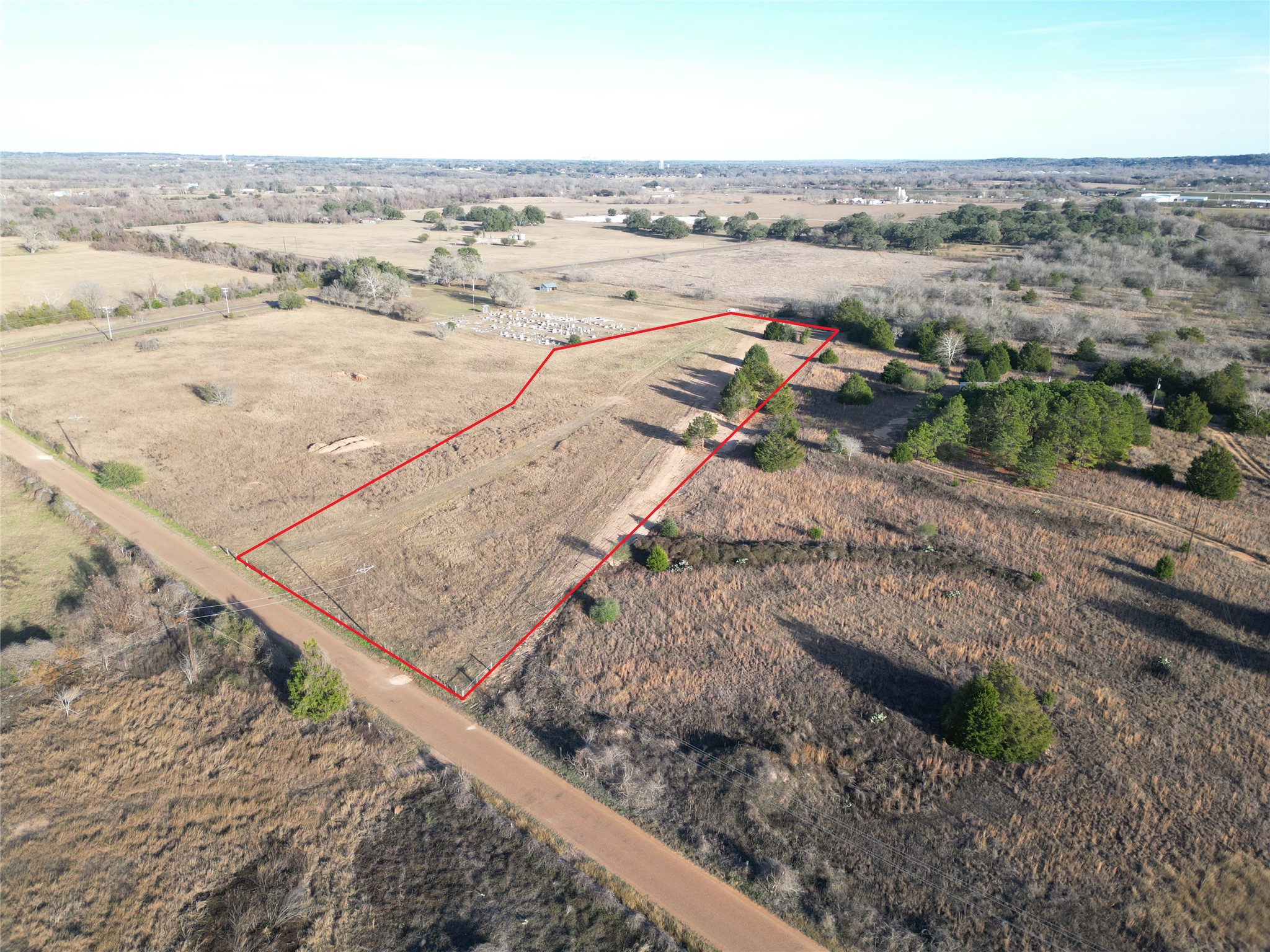 4 Trinity School Road La Grange, TX 78945 - Photo 3 of 11 A spacious countryside lot is bordered by road access and surrounded by mature trees.