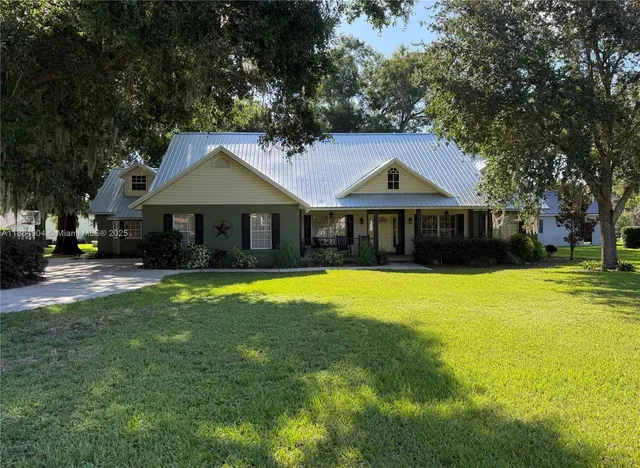 a front view of a house with a yard table and chairs