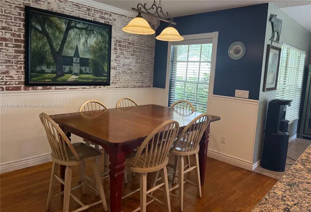 a view of a dining room with furniture and window