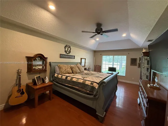 a bedroom with furniture and a flat screen tv