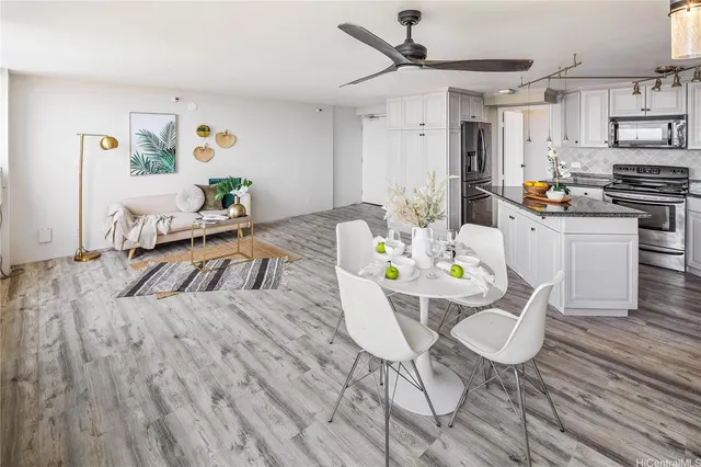 a living room with kitchen island furniture and a wooden floor