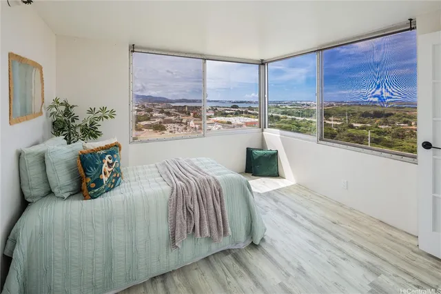 a bed sitting in a bedroom next to a window