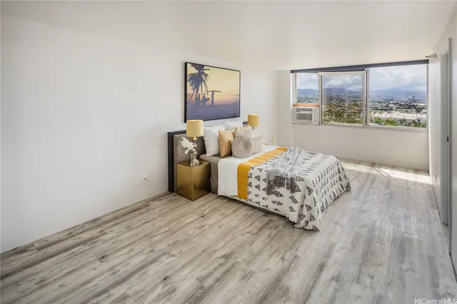 a bed room with a bed and a large window