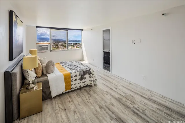 a spacious bedroom with a bed and a large window